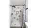 Stylish shower with geometric tile, a sleek showerhead, and convenient in-shower storage at 1300 Wichita Sw Dr, Atlanta, GA 30311