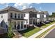 Attractive street view of new construction homes with inviting front porches and well-manicured lawns at 167 Basil Street, Cumming, GA 30040