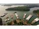 Aerial view showcases covered boat docks, waterfront access, and lush, green surroundings at 167 Basil Street Dr, Cumming, GA 30040