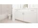Bathroom features a white vanity and a tiled tub/shower combo, offering a clean and functional space at 167 Basil Street Dr, Cumming, GA 30040