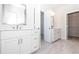 Bathroom featuring double sink vanity with modern fixtures and door to walk-in closet at 167 Basil Street Dr, Cumming, GA 30040