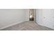 Bedroom featuring a light-colored carpet, neutral walls, and a doorway, providing a blank canvas for personalization at 167 Basil Street Dr, Cumming, GA 30040