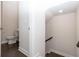 Hallway with access to a downstairs powder room and staircase at 167 Basil Street Dr, Cumming, GA 30040