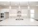 Modern kitchen with white cabinets, granite countertops, and stainless steel appliances at 167 Basil Street Dr, Cumming, GA 30040