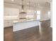 Contemporary kitchen design featuring a large island, stylish pendant lights, and stainless steel hood at 167 Basil Street Dr, Cumming, GA 30040