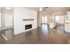 Open concept living room and kitchen featuring hardwood floors and a fireplace at 167 Basil Street Dr, Cumming, GA 30040