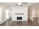 Spacious living room features hardwood floors, a ceiling fan, and a modern fireplace at 167 Basil Street Dr, Cumming, GA 30040