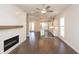 Open concept living room and kitchen featuring hardwood floors and a fireplace at 167 Basil Street Dr, Cumming, GA 30040