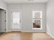 Room showcasing hardwood floors, neutral walls, a window and door to the outside, providing natural light and access at 167 Basil Street Dr, Cumming, GA 30040