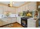 Well-lit kitchen featuring white cabinetry, stainless steel appliances, and a tile backsplash at 2083 Bohler Nw Rd, Atlanta, GA 30318