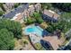 Aerial view showcasing a community pool and well-maintained townhomes in a serene setting at 3721 Stonewall Se Cir, Atlanta, GA 30339