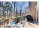 Cozy back porch features wood floors, a grill, seating, and scenic views of the surrounding trees and nature at 3721 Stonewall Se Cir, Atlanta, GA 30339