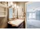 Bathroom featuring modern vanity with chrome faucet, decorative wall shelves, and view of adjoining bedroom at 3721 Stonewall Se Cir, Atlanta, GA 30339