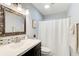 Bathroom featuring a decorative mirror, modern vanity, and shower with white curtain at 3721 Stonewall Se Cir, Atlanta, GA 30339