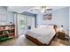 Well-lit bedroom featuring a queen size bed, laminate flooring, and access to exterior patio at 3721 Stonewall Se Cir, Atlanta, GA 30339