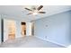 Large bedroom with a ceiling fan, closet, and two doorways at 3721 Stonewall Se Cir, Atlanta, GA 30339