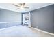 Serene bedroom with soft gray walls, carpet flooring, and a bright window with white curtains at 3721 Stonewall Se Cir, Atlanta, GA 30339