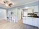 Open layout shows the kitchen area with white cabinets, black countertops, and stainless steel appliances at 3721 Stonewall Se Cir, Atlanta, GA 30339