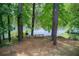 View of the lake, bench and charcoal grill in the backyard at 3721 Stonewall Se Cir, Atlanta, GA 30339