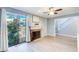 Bright living room with hardwood floors, fireplace, glass door leading to an outdoor space, and a staircase at 3721 Stonewall Se Cir, Atlanta, GA 30339