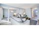 Open-concept living area featuring comfortable sofas, light-colored walls, and wood-look flooring at 3721 Stonewall Se Cir, Atlanta, GA 30339