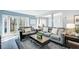 Comfortable living room featuring modern sofas, hardwood floors, large windows, and stylish decor for a cozy atmosphere at 3721 Stonewall Se Cir, Atlanta, GA 30339