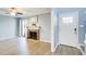 Cozy living room featuring a brick fireplace, hardwood floors, and a glass door opening to the outdoor area at 3721 Stonewall Se Cir, Atlanta, GA 30339