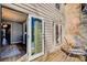 Charming outdoor patio with wood decking, chair, and sliding door access to interior space at 3721 Stonewall Se Cir, Atlanta, GA 30339