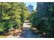 Street view leading to property, showcasing mature trees and landscaping at 3721 Stonewall Se Cir, Atlanta, GA 30339