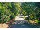Scenic street view leading to the property, surrounded by lush greenery and mature trees at 3721 Stonewall Se Cir, Atlanta, GA 30339