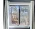 The window showcases a tranquil scene of nature and a glimpse of neighboring architecture at 3721 Stonewall Se Cir, Atlanta, GA 30339