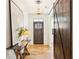 Welcoming entryway featuring a wooden door, stylish lighting, and a rustic console table with unique decor at 1977 Westwood Se Cir, Smyrna, GA 30080