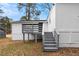 Exterior view of back of house with a deck and stairs to the backyard at 2966 Knollberry Ln, Decatur, GA 30034