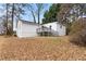 An angle view of house exterior showing the backyard with leaves at 2966 Knollberry Ln, Decatur, GA 30034