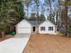 Charming one-story home with white siding, stone accents, and a well-manicured front yard at 2966 Knollberry Ln, Decatur, GA 30034