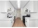 Modern kitchen boasts white cabinets, stainless steel appliances, and sleek countertops at 2966 Knollberry Ln, Decatur, GA 30034