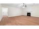 Bright living room with laminate floors, a ceiling fan, and a fireplace for cozy evenings at 2966 Knollberry Ln, Decatur, GA 30034