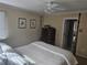 Bedroom featuring neutral walls, ceiling fan, and four poster bed with chest of drawers at 9 Ridgemere Trce Trce, Atlanta, GA 30328