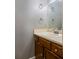 Bathroom featuring vanity with cream countertop, wood cabinets, and decorative towel rings at 4971 Jenny Dr, Acworth, GA 30101