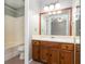 A bathroom with a tub, toilet, vanity, and wooden cabinets at 4971 Jenny Dr, Acworth, GA 30101