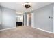 A spacious bedroom with a ceiling fan, carpet, and neutral colored walls at 4971 Jenny Dr, Acworth, GA 30101