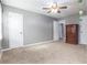 Bedroom with neutral carpet, gray walls, ample closet space, and modern ceiling fan at 4971 Jenny Dr, Acworth, GA 30101