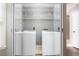 Bright laundry area with modern, stacked washer and dryer at 4971 Jenny Dr, Acworth, GA 30101