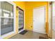 Sunroom with yellow siding, glass pane windows and black paneled entry door at 4971 Jenny Dr, Acworth, GA 30101