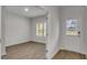 Light filled entryway with wood flooring, a window with blinds, and a white front door at 643 Egrets Lot 52 Lndg, Covington, GA 30014