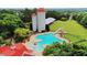 Aerial view of a large community pool featuring a slide, lounge chairs, red umbrellas, and unique silo structures at 643 Egrets Lot 52 Lndg, Covington, GA 30014