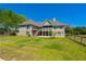 Spacious backyard featuring a well-maintained lawn, a deck, a screened porch, and a fenced yard at 815 Spring View Ct, Covington, GA 30014