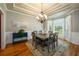 Formal dining room with hardwood floors, elegant chandelier, and wainscoting at 815 Spring View Ct, Covington, GA 30014