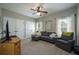 Relaxing living room featuring soft gray seating, neutral carpet, and natural light at 815 Spring View Ct, Covington, GA 30014