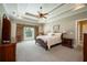 Spacious main bedroom with a tray ceiling, ceiling fan, and large window at 815 Spring View Ct, Covington, GA 30014